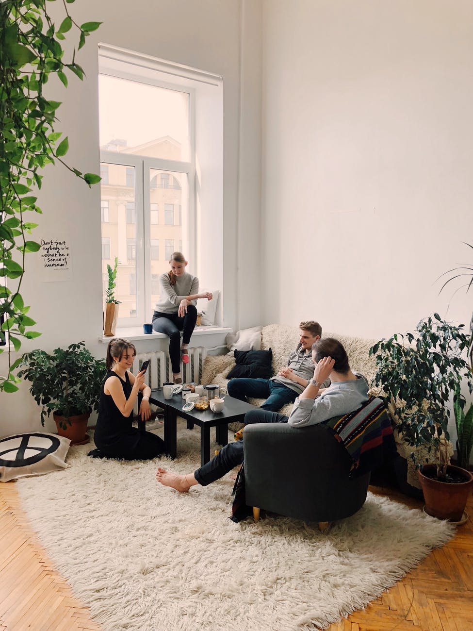 people gathered inside house sitting on sofa